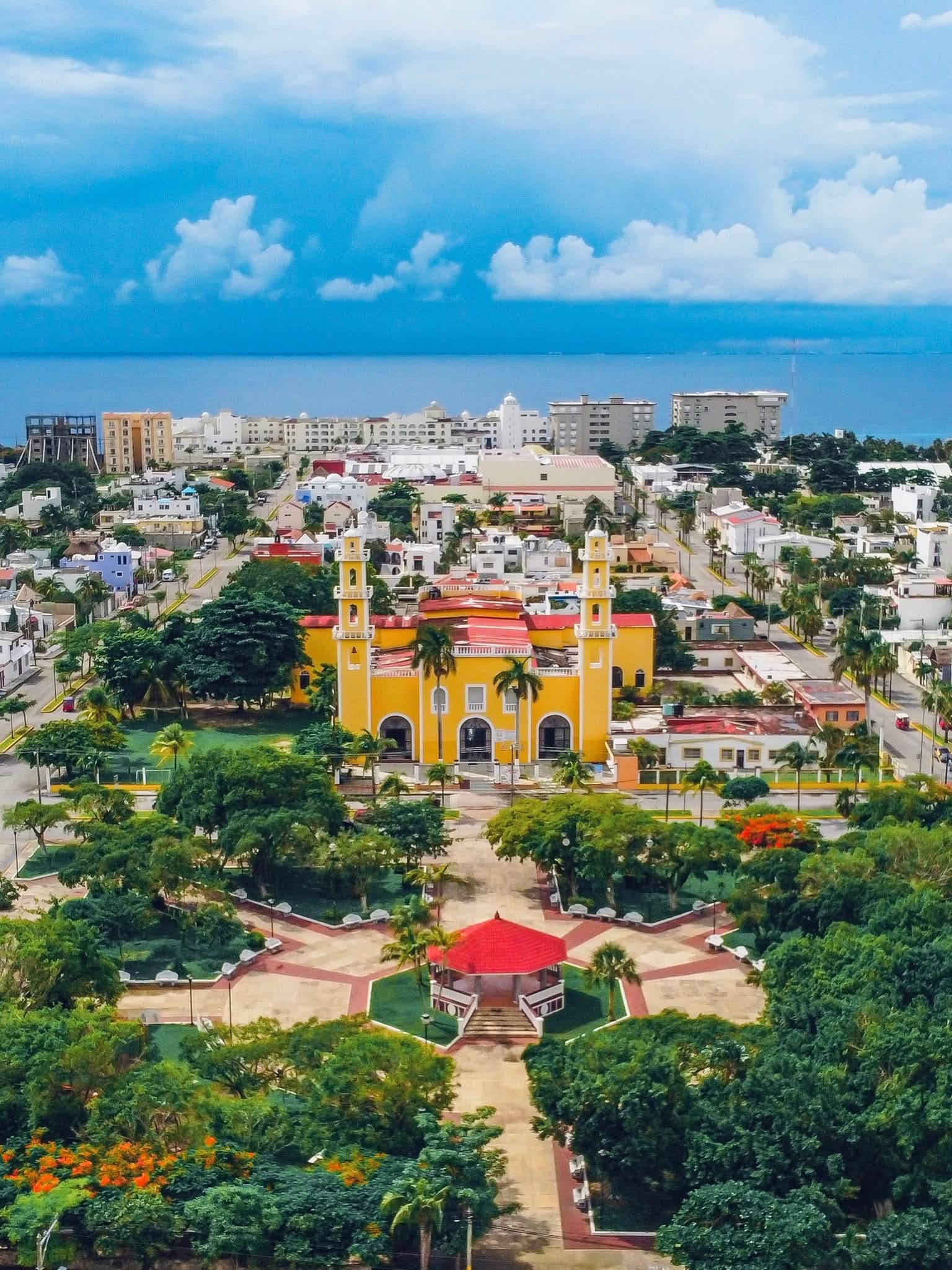 Aerial view of Cozumel island showing turquoise waters, white sand beaches and lush green interior